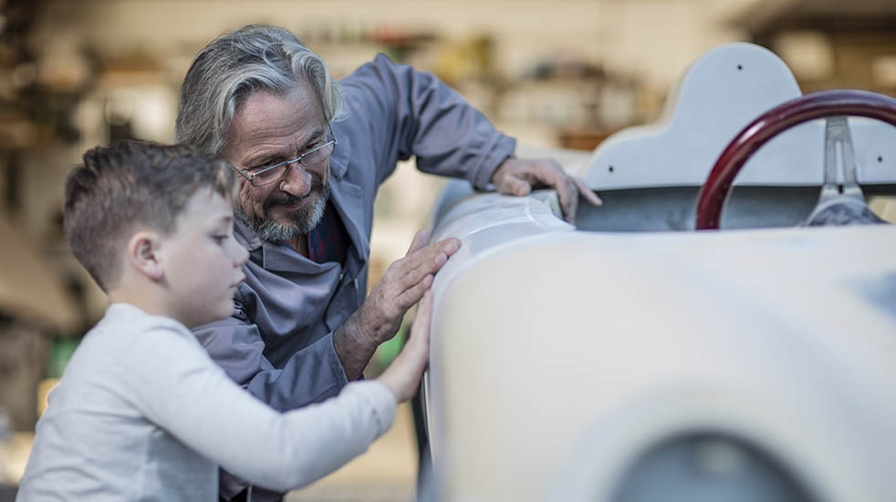 Restoring a classic car; man and boy